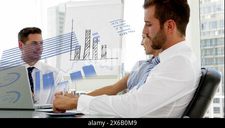 Image of statistical data processing over diverse businesspeople discussing at office Stock Photo