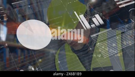 Image of graphs and data over caucasian male warehouse worker using tablet Stock Photo