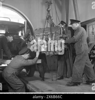 Diesel engine 1942. The Örebro fire brigade services and repairs its own fire trucks. They are knowledgeable in mechanics and can be seen here with a larger Volvo diesel engine to be installed in the fire truck. 1942. Kristoffersson ref H31-2 Stock Photo