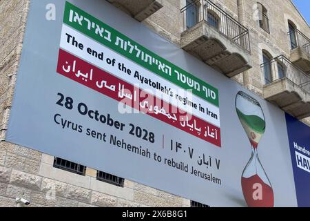 JERUSALEM - MAY 6: A billboard funded by an Evangelical group on the building housing The Friends of Zion FOZ Museum which celebrates Christian Zionists and their contribution to Israel, predicts Iran's Ayatollah-led government will fall by October 28, 2028. The statement displays an hourglass depicting the regime's decline on May 6, 2024 in Jerusalem. Kamal Kharrazi, an adviser to Iran's Supreme Leader Ayatollah Ali Khamenei, warned Tehran would rethink its nuclear doctrine if Israel threatens its existence amid West Asian upheaval after the Gaza war. Stock Photo