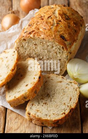 Rustic traditional onion bread closeup on the wooden board on the table. Vertical Stock Photo