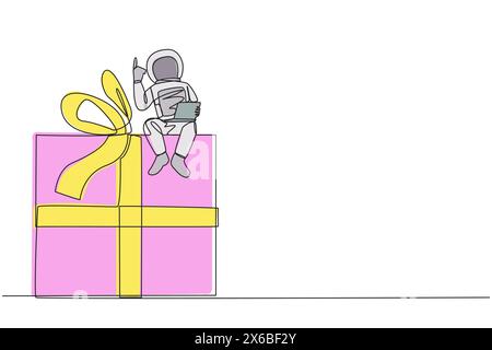 Continuous one line drawing young energetic astronaut sitting on giant gift box holding laptop raise one hand. Awesome space gift. Cosmonaut outer spa Stock Vector