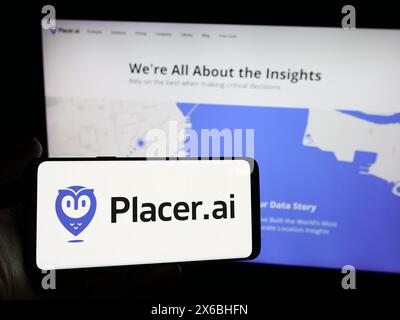 Person holding smartphone with logo of US traffic analytics software company Placer Labs Inc. in front of website. Focus on phone display. Stock Photo