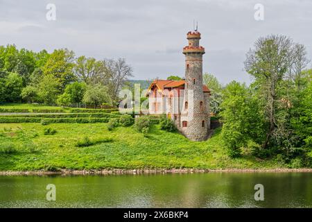 Historical castle villa near dam in the Czech Republic, Europe, with towers called Stock Photo