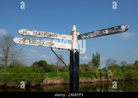 Signpost showing possible destinations from the point where the Birmingham Worcester canal meets the River Severn near Diglis Basin in Worcester. Stock Photo