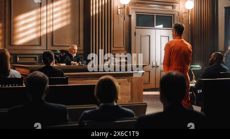 Court of Law and Justice Trial: Imparcial Honorable Judge Pronouncing Sentence, Striking Gavel. Shot of Male Lawbreaker in Orange Robe Sentenced to Serve Time in Prison. Hearing Adjourned, Stock Photo