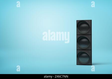 Stacked black speakers on blue background Stock Photo