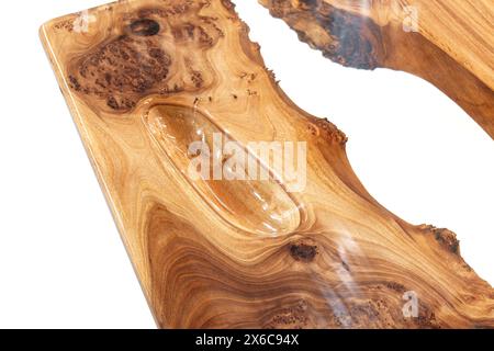 Live edge elm burl slab table top with central epoxy resin river on white background, combining natural wood with a synthetic material close view Stock Photo