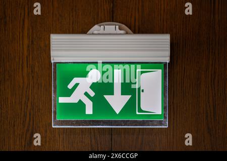 modern emergency exit sign showing emergency exit downwards Stock Photo