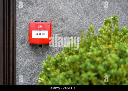 Full front view of outdoor wall mounted fire alarm button Stock Photo