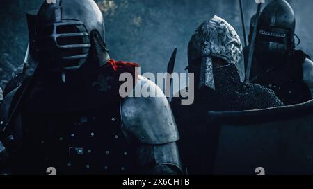 Epic Invading Army of Medieval Soldiers Marching on Battlefield, Armored Warriors with Swords. War, Battle, Conquest. Dramatic Historical Reenactment. Stock Photo