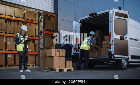 Outside of Logistics Distributions Warehouse With Inventory Manager Using Tablet Computer, talking to Worker Loading Delivery Truck with Cardboard Boxes. Online Orders, Purchases, E-Commerce Goods Stock Photo