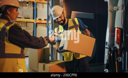 Outside of Logistics Retail Warehouse: Manager Using Tablet Computer and Scanner, talking to Worker Loading Delivery Truck with Cardboard Boxes, Online Orders, Medicine Supply, E-Commerce. Evening Stock Photo