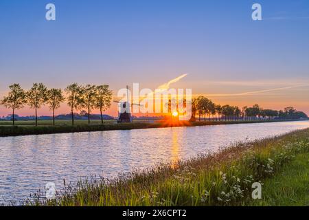 A sunrise in the spring at the Zwakkenburger Mill (usually called Zwakkenburger), a polder mill south of the village of Niezijl, east of Grijpskerk ne Stock Photo