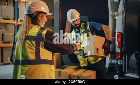 Outside of Logistics Retail Warehouse: Manager Using Tablet Computer and Scanner, talking to Worker Loading Delivery Truck with Cardboard Boxes, Online Orders, Medicine Supply, E-Commerce. Evening Stock Photo