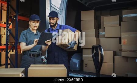 Outside of Logistics Distributions Warehouse With Female Manager Using Tablet Computer, talking to Worker Loading Delivery Truck with Cardboard Boxes. Online Orders, Purchases, E-Commerce Goods Stock Photo