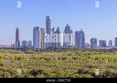 Editorial: BUENOS AIRES, ARGENTINA, January 20, 2024 - New buildings in the Puerto Madeira district in Buenos Aires with the nature reserve in the for Stock Photo