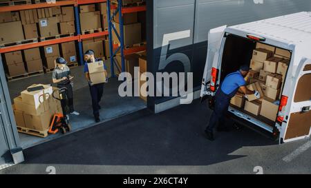 Outside of Logistics Distributions Warehouse with Diverse Team of Professional Workers Loading Delivery Truck with Cardboard Boxes, Online Orders, Purchases, E-Commerce Goods. High Angle Shot Stock Photo