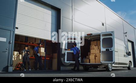 Outside of Logistics Distributions Warehouse With Manager Using Tablet Computer, Workers Start Loading Delivery Truck with Cardboard Boxes. Online Orders, Purchases, E-Commerce Goods. Stock Photo