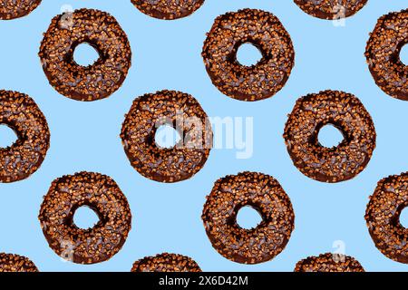 Creative pattern of chocolate donuts with holes on a blue background. Stock Photo