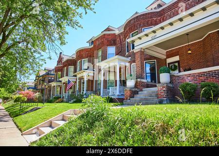 Charming Red Brick Row Houses with American Flags, Suburban USA Stock Photo