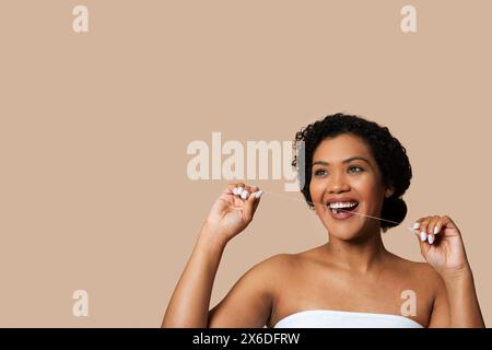 Joyful Woman With Short Curly Hair Flossing Teeth Stock Photo
