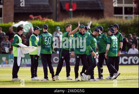 Ireland's Craig Young celebrates with team mates after taking the wicket of Pakistan's Babar Azam during the third T20 international at the Castle Avenue Cricket Ground, Dublin. Picture date: Tuesday May 14, 2024. Stock Photo