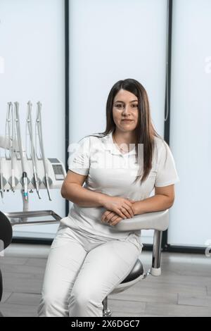 With an expression of care and aesthetics, the dentist demonstrates her beauty, creating a harmonious atmosphere in the office. The expression in her Stock Photo
