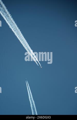 two parallel airplane tracks in the blue sky, contrails Stock Photo - Alamy
