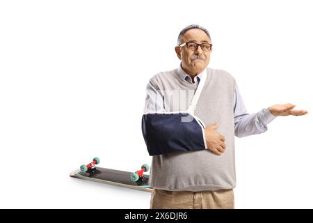 Disappointed mature man with a broken arm injured from a skateboard fall isolated on white background Stock Photo