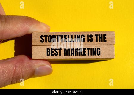 Storytelling is the best marketing words written on wooden blocks with yellow background. Conceptual storytelling is the best marketing symbol. Copy s Stock Photo
