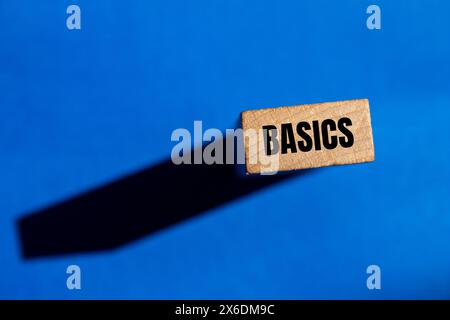 Basics word written on wooden block with blue background. Conceptual basics word symbol. Copy space. Stock Photo