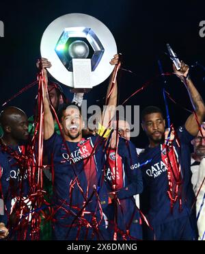 PARIS, FRANCE - MAY 12: Marquinhos, Danilo Pereira, Presnel Kimpembe of Paris Saint-Germain on podium celebrate lifting the trophy at the presentation Stock Photo