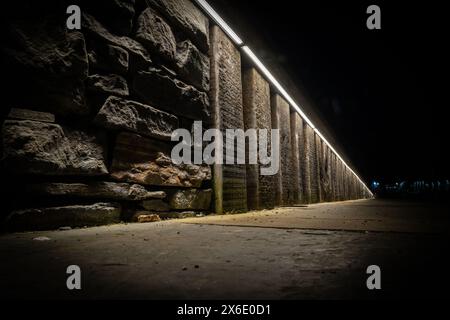 The pavement, wall and lighting on the main road through Ullapool, leading to the ferry port. Stock Photo
