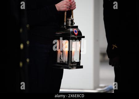 France's Freedom Flame is carried during a ceremony at Portsmouth International Port. The Flamme de la Liberte, which normally resides under Paris' Arc de Triomphe, was brought by ferry to Portsmouth before departing for Arlington, Virginia, USA. The move is to pay thanks to the UK and USA as part of D-Day 80th anniversary commemorations. Picture date: Tuesday May 14, 2024. Stock Photo