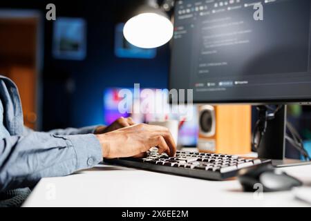 Hardware expert using software programming to ensure server security, working with binary code and html script on terminal window. IT technician engineer develops system database protection. Stock Photo