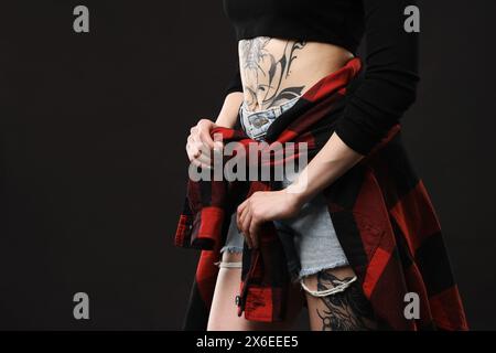 Woman with cool tattoos on black background, closeup. Space for text Stock Photo