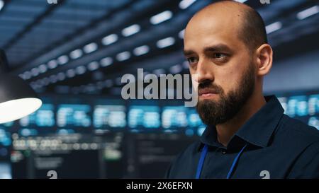 Close up on programmer in server farm safeguarding data from intruding hackers. Developer protecting server rows against unauthorized access, securing system from ransomware attacks Stock Photo