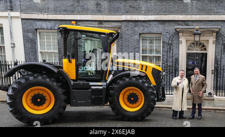 London, UK. 14th May, 2024. A JCB tractor is parked outside No 10 for the summit. Attendees arrive in Downing Street for the Farm to Form Summit hosted by the Prime Minister, including those from farming, food retail and the fruit and vegetables sectors in the UK. Credit: Imageplotter/Alamy Live News Stock Photo