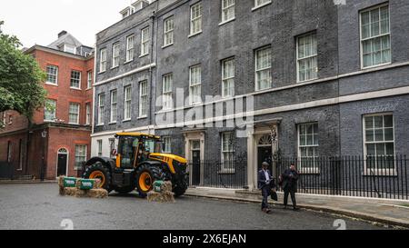 London, UK. 14th May, 2024. A JCB tractor is parked outside No 10 for the summit. Attendees arrive in Downing Street for the Farm to Form Summit hosted by the Prime Minister, including those from farming, food retail and the fruit and vegetables sectors in the UK. Credit: Imageplotter/Alamy Live News Stock Photo