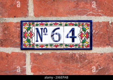Ornate floral ceramic number 64 panel Stock Photo