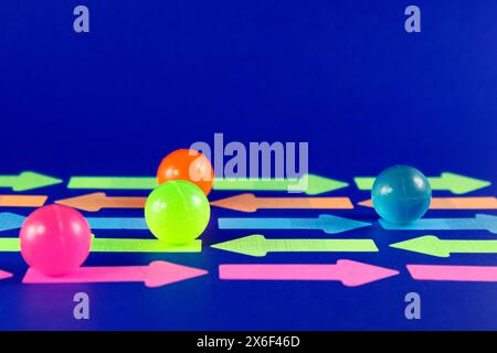 Spheres moving on arrows that go in different directions Stock Photo