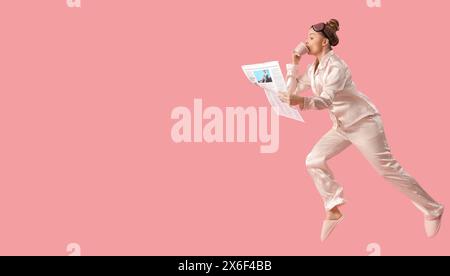 Running young woman with morning newspaper and coffee on pink background with space for text Stock Photo