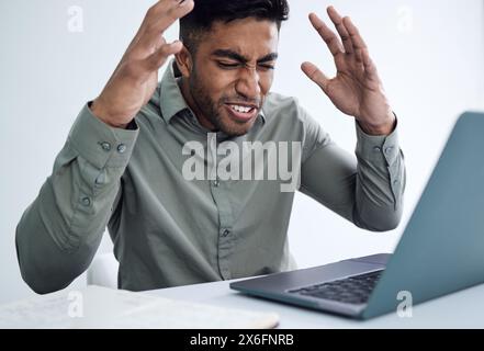 Stress, angry or business man on laptop for disaster, financial crisis or reading bankruptcy email in office. Frustrated professional, annoyed and Stock Photo