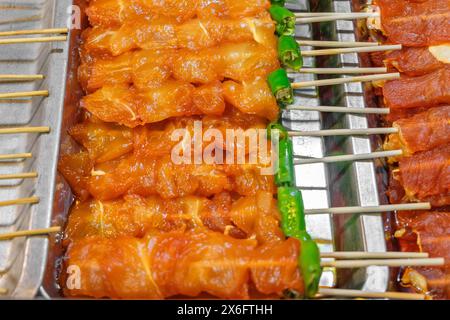 grilled chicken skewers with sweet sauce on food stall, selective focus Stock Photo