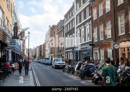 Dean Street in Central London Soho, London architecture Quo Vadis private members club and parked motorbikes and scooters, England,UK Stock Photo