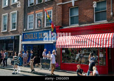 London Soho, Admiral Duncan gay bar and pub beside Algerian Coffee stores shop in Old Compton Street, central London,England,UK,2023 Stock Photo