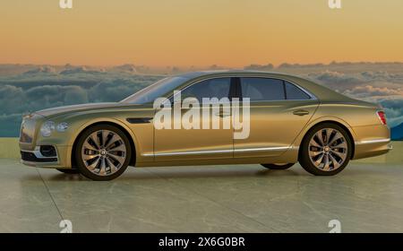 Bentley Flying Spur against a backdrop of clouds Stock Photo