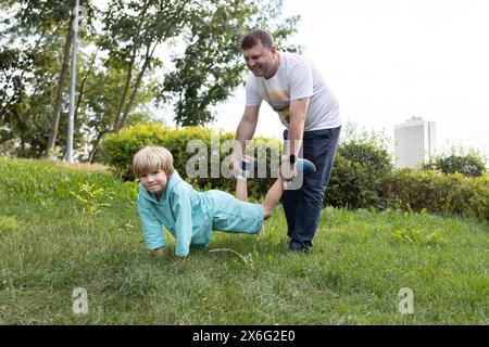 Dad and son are having fun in nature. family together on vacation. Healthy lifestyle, activity. enjoying the moment, a happy childhood, a pleasant pas Stock Photo
