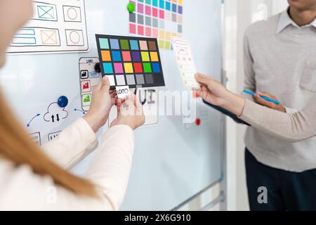UI designers present to team about color design of logo during application design brainstorming. Creative digital development agency. UX UI concept Stock Photo
